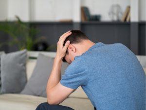 a person experiencing dizziness and nausea due to gas leak exposure indicating a sign of a gas leak