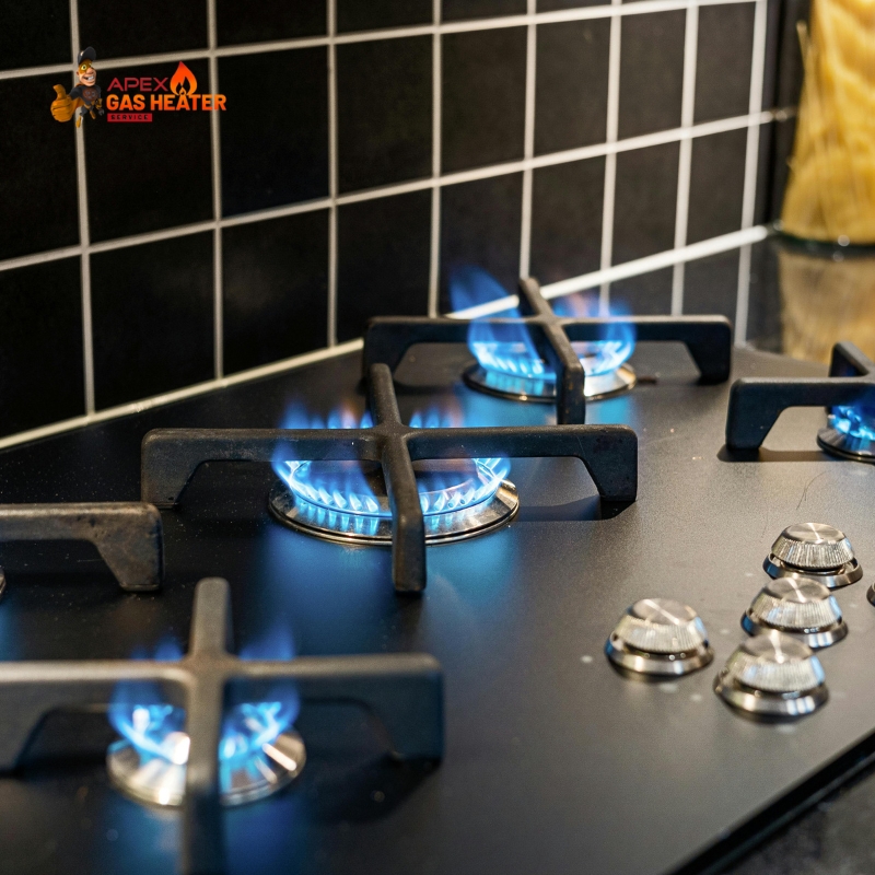 Gas Stove Service And Repair showing four blue flame burners on a modern black stovetop