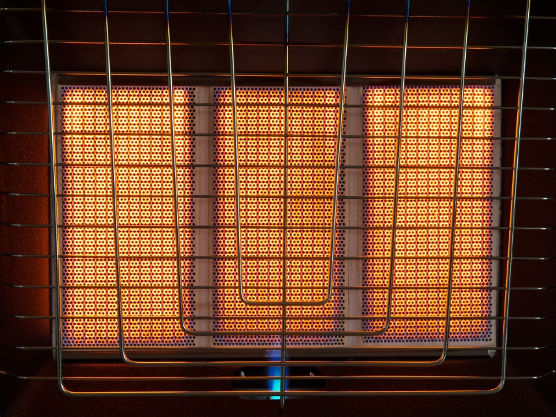 Close-up of gas heater glowing brightly to keep warm in winter indoors.