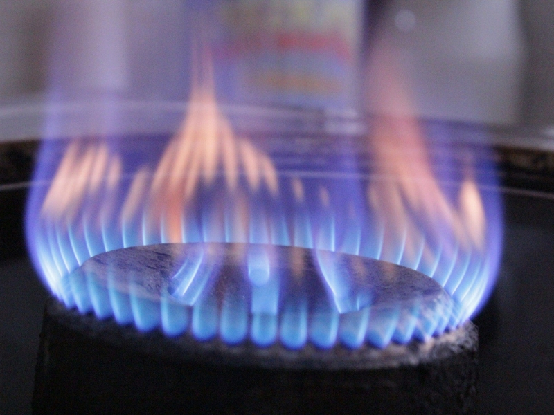 Gas burner showing normal blue flame used for gas pipeline leak detection calibration.